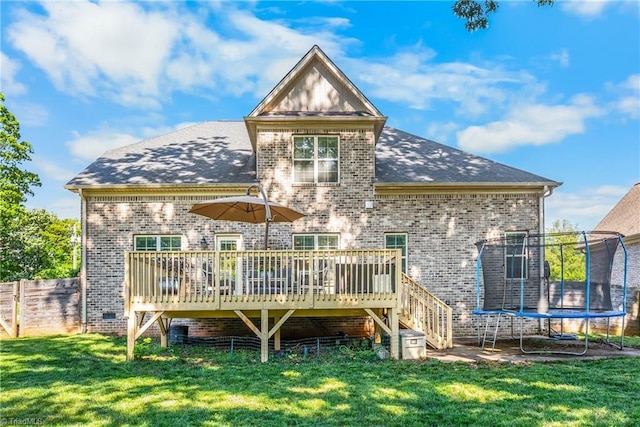 3632 Sally Kirk Rd, Winston-Salem, NC 27106 - rear view of house with a trampoline, a wooden deck, brick siding, a shingled roof, and stairs