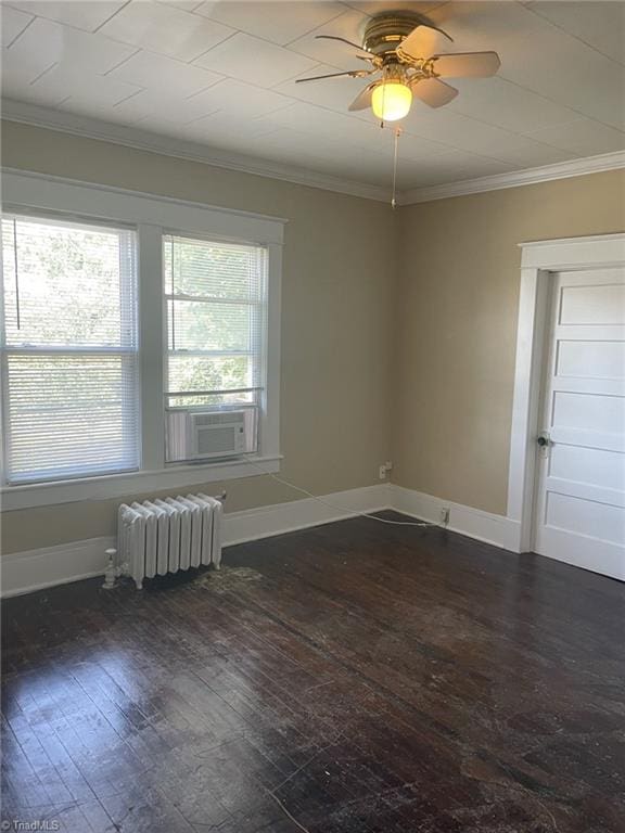 empty room with radiator, dark wood-style floors, ornamental molding, and cooling unit