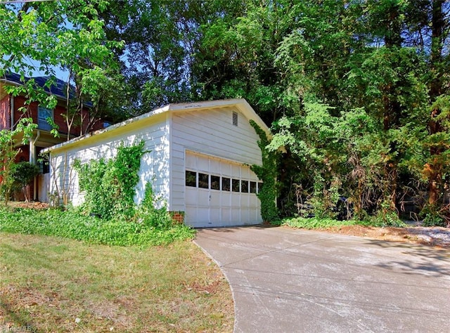 exterior space featuring a garage and an outbuilding