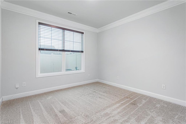 unfurnished room with crown molding and carpet flooring