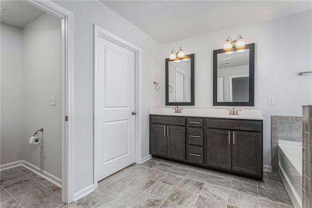 bathroom with vanity and a tub