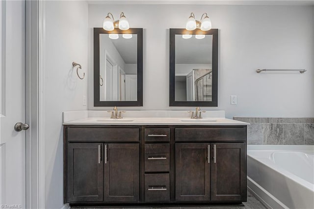 bathroom featuring vanity and a washtub