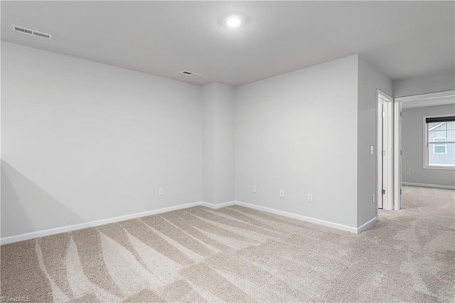 unfurnished room with light carpet