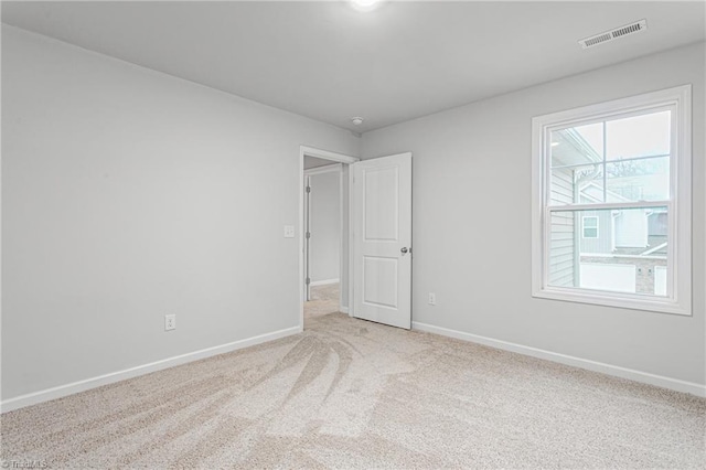 unfurnished room with light carpet