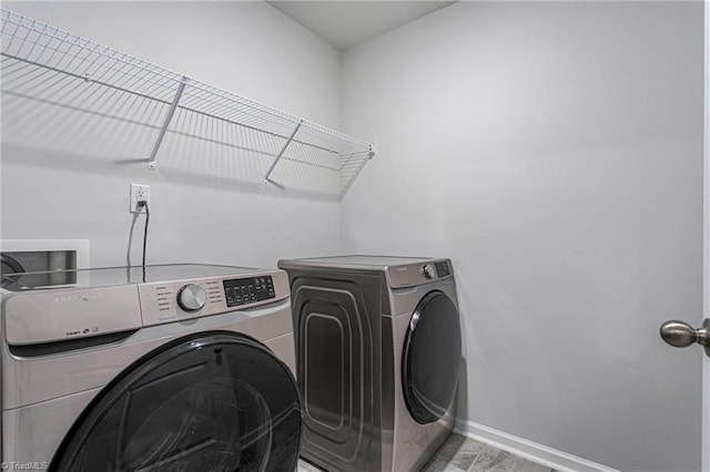 clothes washing area with independent washer and dryer