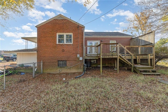 rear view of property with a wooden deck