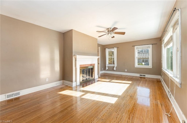 unfurnished living room with ceiling fan and light wood-type flooring