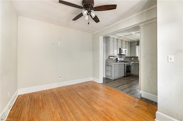 unfurnished living room featuring ceiling fan and dark wood-type flooring