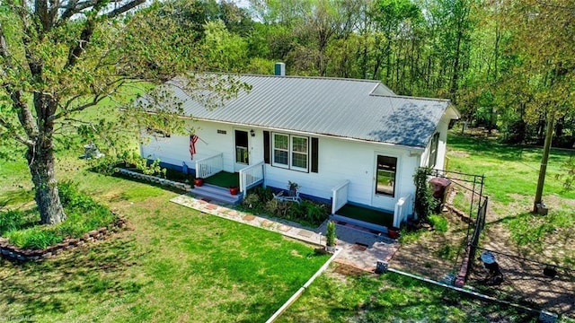 view of front of home featuring a front yard and metal roof