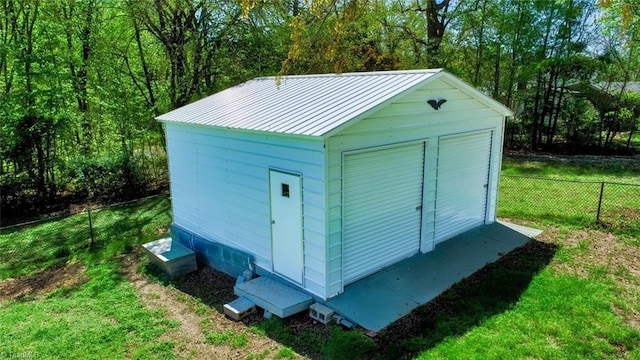 view of shed featuring fence