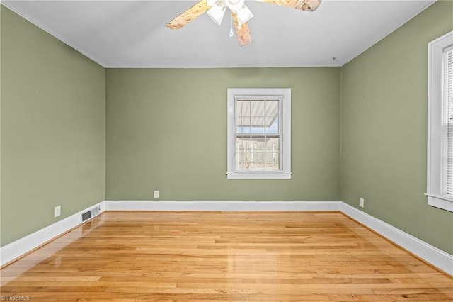 unfurnished room with light wood-type flooring and ceiling fan