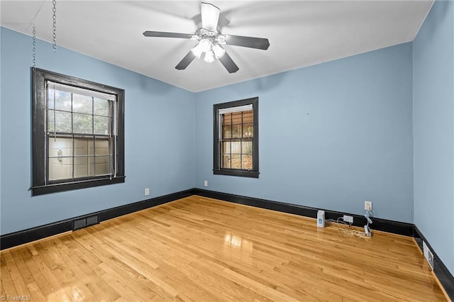 spare room with hardwood / wood-style floors and ceiling fan