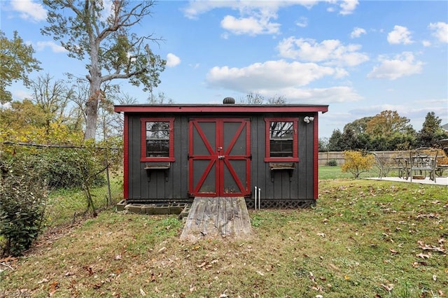 view of outbuilding with a lawn