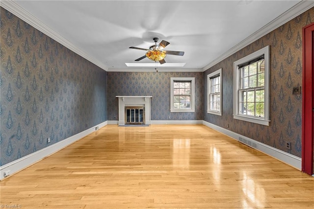 unfurnished living room featuring ornamental molding, light wood-type flooring, and ceiling fan