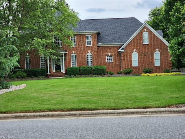 colonial-style house with a front yard