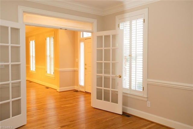 doorway to outside with hardwood / wood-style floors, french doors, and ornamental molding