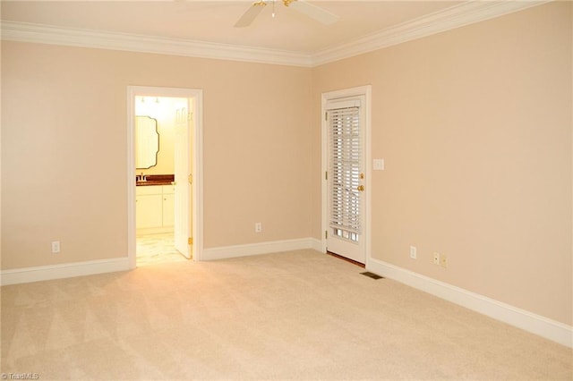 unfurnished room featuring light carpet, ceiling fan, and crown molding