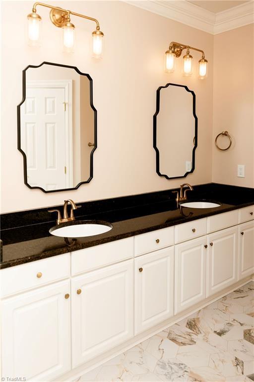 bathroom with vanity and ornamental molding