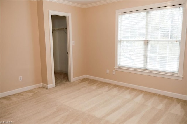 unfurnished bedroom featuring light carpet, a closet, a spacious closet, and multiple windows