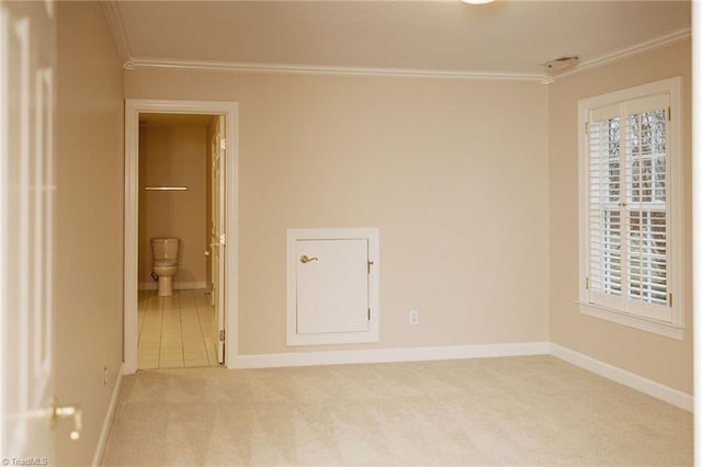 carpeted empty room featuring ornamental molding