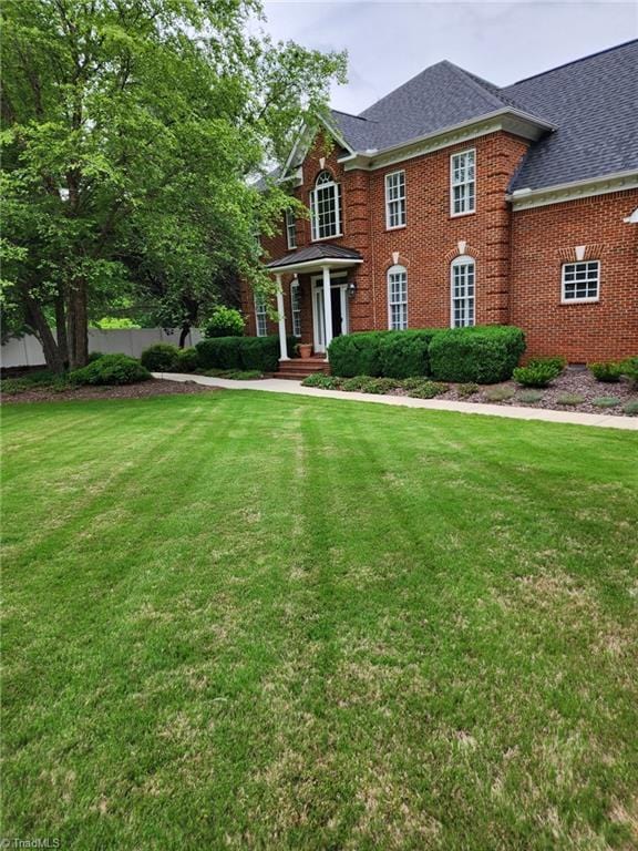 colonial inspired home with a front yard