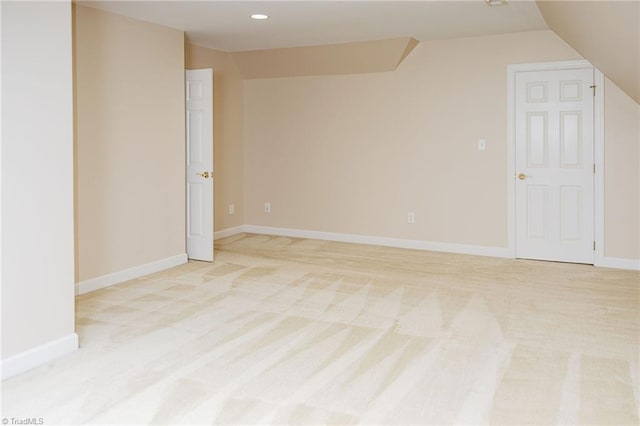 unfurnished room with light carpet and lofted ceiling