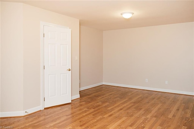 spare room featuring wood-type flooring