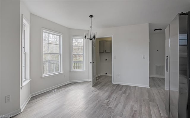 interior space with a chandelier and light hardwood / wood-style floors