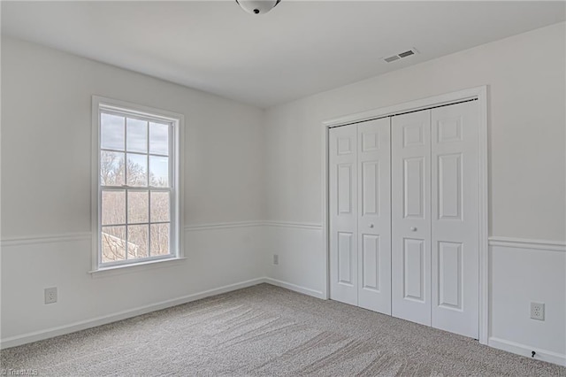 unfurnished bedroom with carpet flooring and a closet