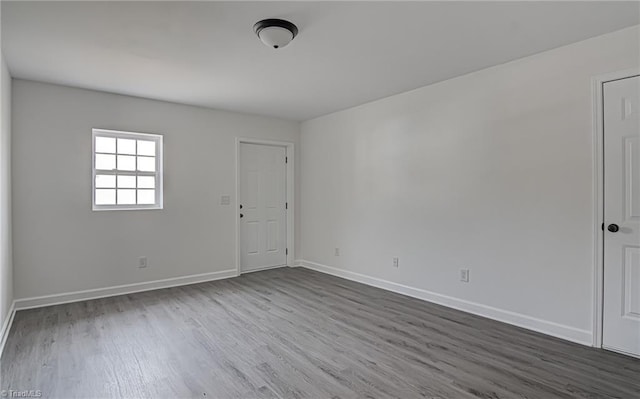 unfurnished room with hardwood / wood-style flooring