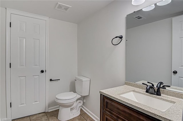 bathroom featuring toilet, vanity, and tile patterned floors