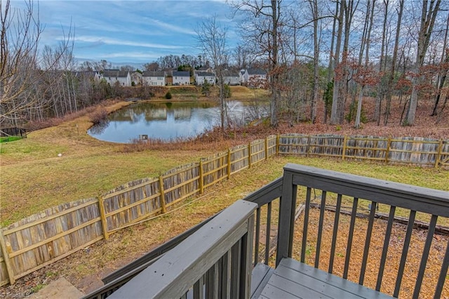 wooden terrace featuring a yard and a water view