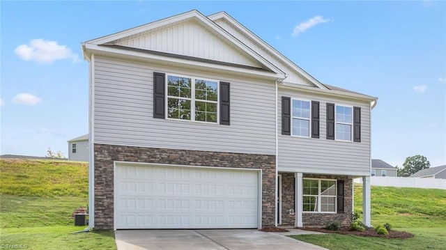 view of front of house featuring a garage and a front lawn