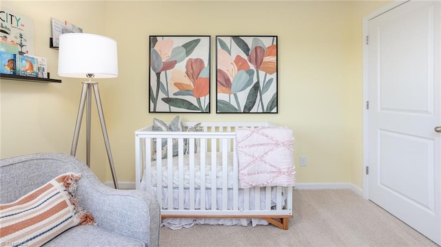 carpeted bedroom with a nursery area