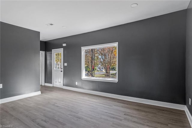 empty room with hardwood / wood-style floors