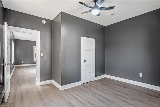 spare room with light wood-type flooring and ceiling fan