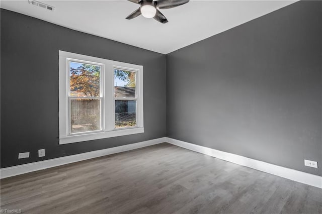 unfurnished room with hardwood / wood-style flooring and ceiling fan