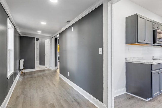 hall featuring ornamental molding and light wood-type flooring