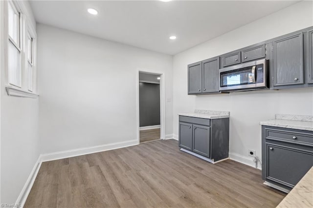 kitchen featuring gray cabinetry and dark hardwood / wood-style flooring