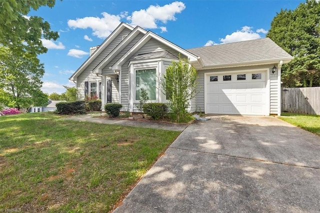 single story home with fence, driveway, a front yard, and an attached garage