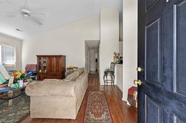 living area with lofted ceiling, a ceiling fan, wood finished floors, and visible vents