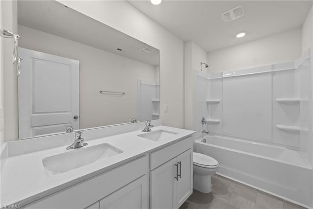 full bathroom featuring vanity,  shower combination, and toilet