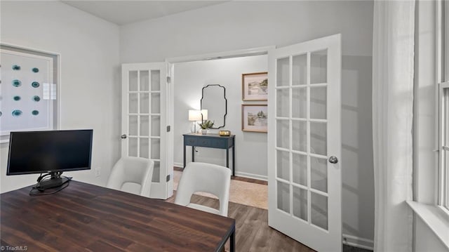 home office with french doors and hardwood / wood-style flooring