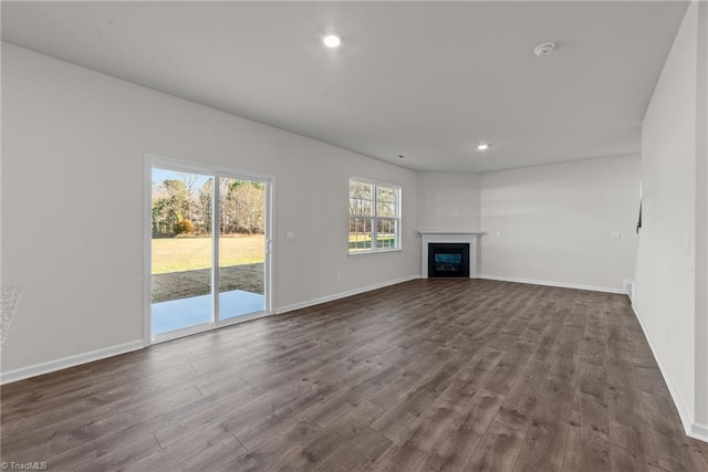 unfurnished living room with dark hardwood / wood-style flooring