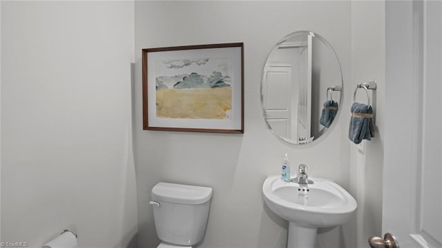 bathroom featuring toilet and sink