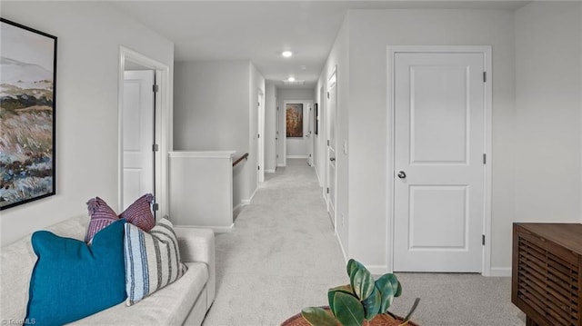 hallway with light colored carpet