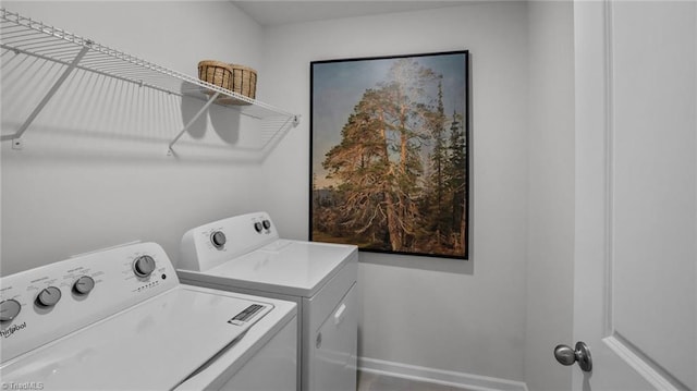 clothes washing area with washer and clothes dryer