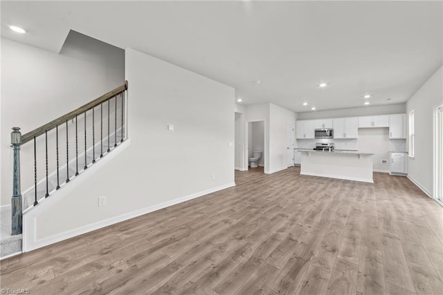 unfurnished living room with light hardwood / wood-style flooring