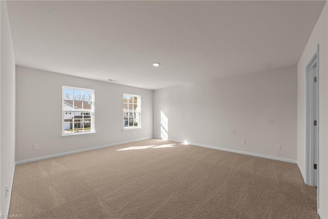 unfurnished room featuring light colored carpet