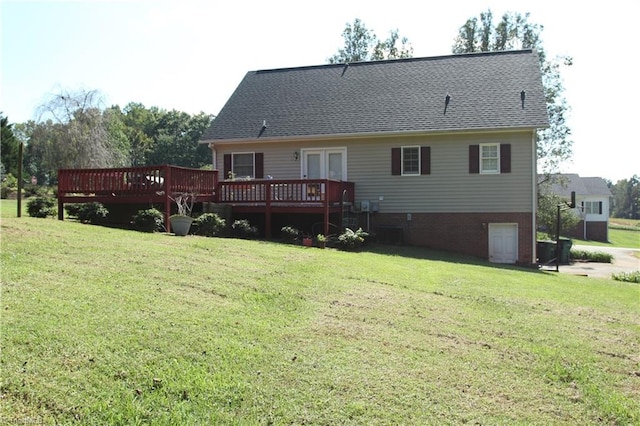 back of property featuring a deck and a lawn